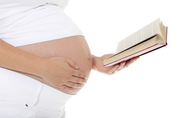 Pregnant woman reading a book